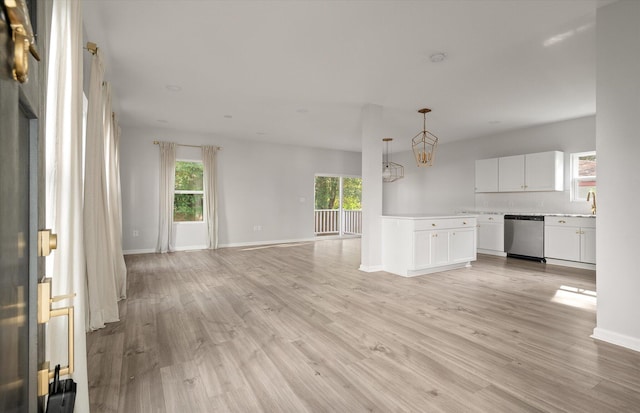 5748 Pilgrim Ave Unit D, Hanahan, SC 29410 - unfurnished living room with light wood-style flooring, a chandelier, a sink, and baseboards