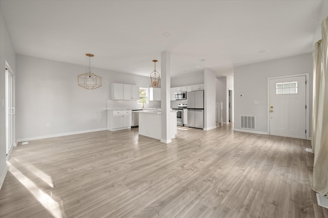 5748 Pilgrim Ave Unit D, Hanahan, SC 29410 - unfurnished living room with light wood-type flooring and baseboards