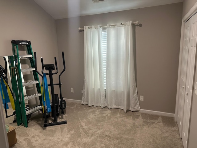 workout room featuring light colored carpet