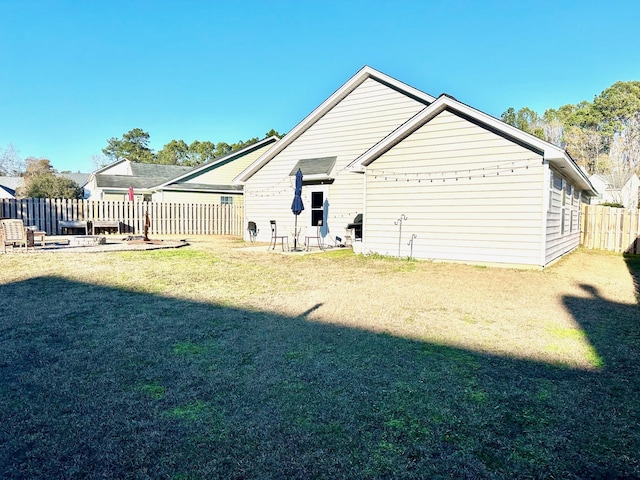 rear view of property with a lawn