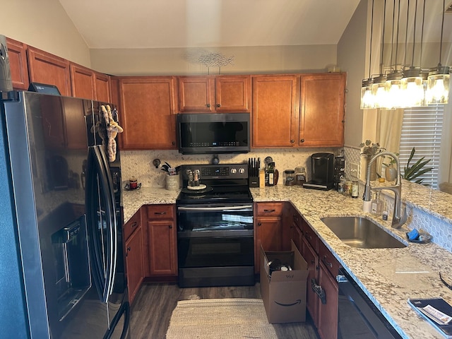 kitchen with light stone countertops, dark wood-type flooring, sink, and black appliances