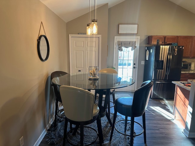 dining area with dark hardwood / wood-style flooring and lofted ceiling