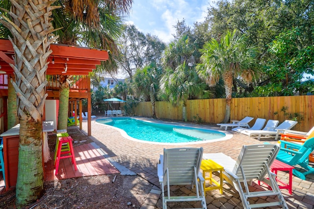 view of swimming pool with a patio area, a fenced backyard, and a fenced in pool