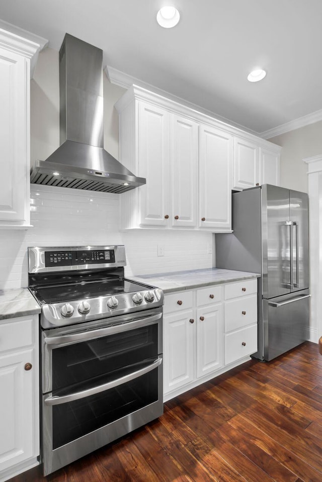 kitchen featuring dark wood-type flooring, white cabinetry, stainless steel appliances, island range hood, and ornamental molding