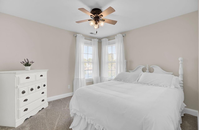 bedroom featuring light colored carpet and ceiling fan