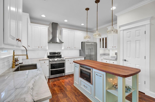 kitchen featuring white cabinetry, light stone countertops, wall chimney exhaust hood, and appliances with stainless steel finishes