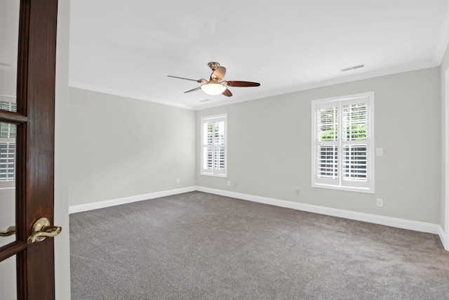 carpeted empty room featuring ceiling fan and crown molding