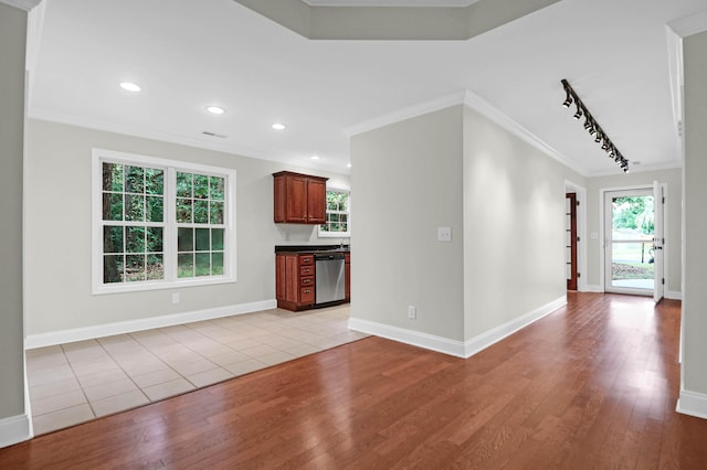 unfurnished living room with track lighting, crown molding, and light hardwood / wood-style floors