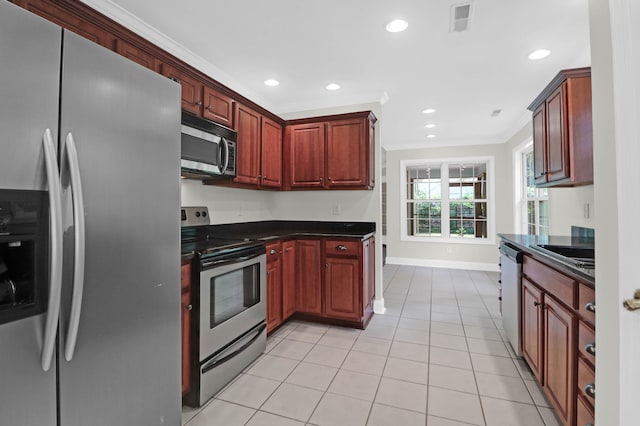 kitchen featuring light tile patterned flooring, sink, crown molding, and appliances with stainless steel finishes