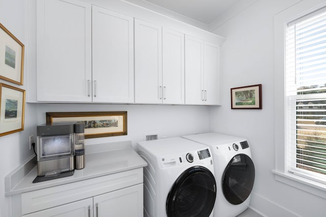 laundry area with washer and dryer and cabinet space