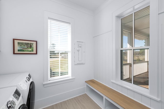 laundry area with laundry area, separate washer and dryer, baseboards, and ornamental molding