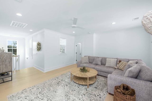 living area with wood finished floors, recessed lighting, visible vents, and baseboards