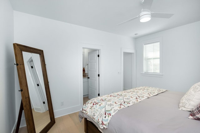 bedroom featuring light wood-style flooring, ensuite bathroom, and ceiling fan