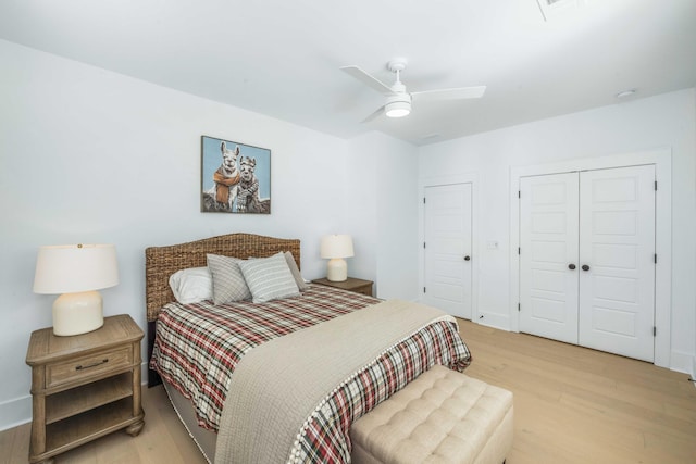 bedroom with ceiling fan, visible vents, baseboards, and light wood-style flooring