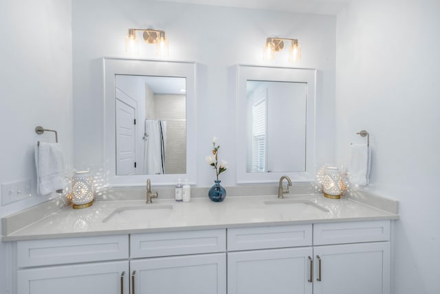 full bathroom with a sink, a shower with shower curtain, and double vanity