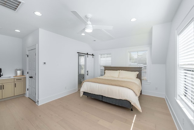 bedroom with recessed lighting, light wood-style floors, visible vents, and baseboards