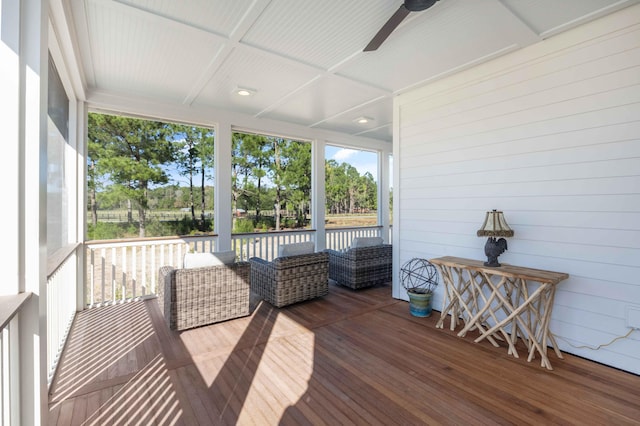 sunroom / solarium with a ceiling fan