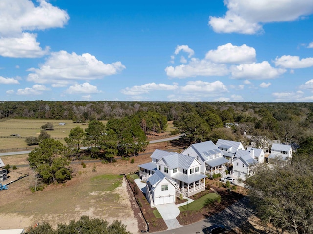 birds eye view of property featuring a forest view