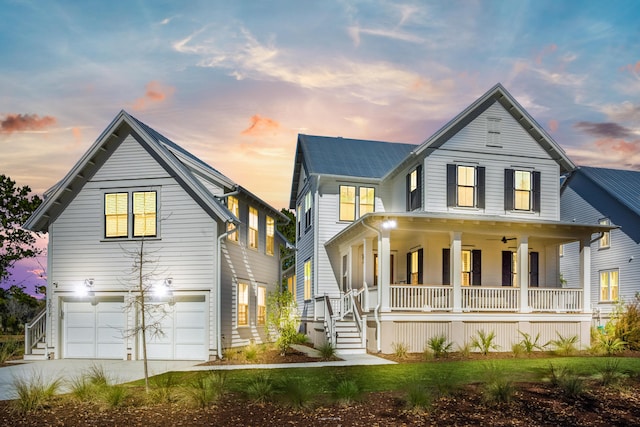 view of front of property featuring a porch, driveway, and a garage