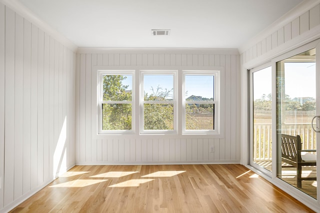 unfurnished sunroom with plenty of natural light and visible vents