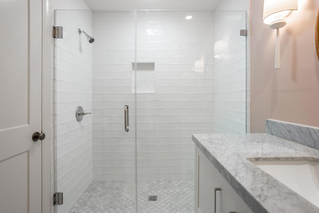 bathroom with a stall shower and vanity