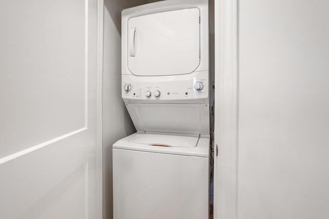 laundry area with stacked washer and clothes dryer and laundry area