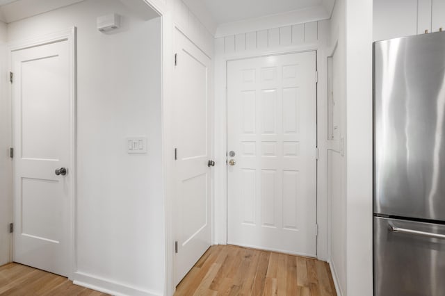 hallway with light wood-style floors