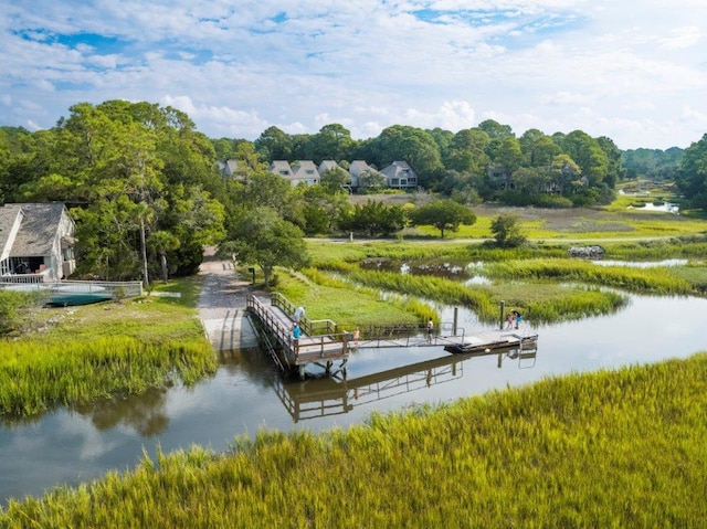 surrounding community with a water view and a floating dock