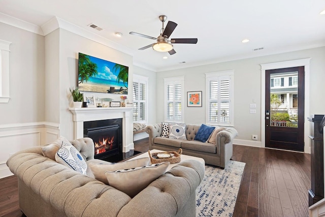 living room with dark hardwood / wood-style floors, ceiling fan, and crown molding