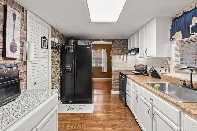 kitchen with electric stove, white cabinetry, black refrigerator with ice dispenser, hardwood / wood-style flooring, and sink