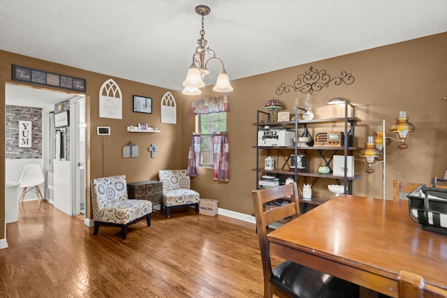 office space featuring wood-type flooring, a textured ceiling, and a chandelier