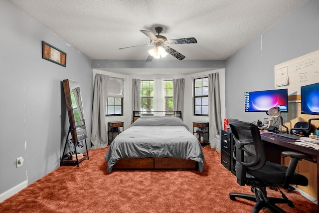 carpeted bedroom with ceiling fan and a textured ceiling