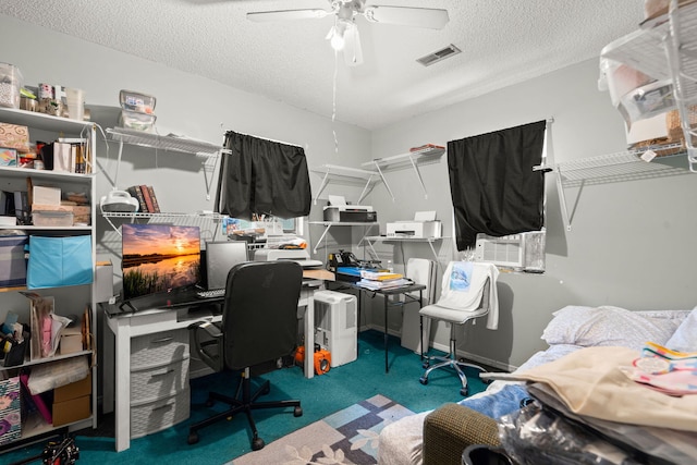 carpeted office space featuring a textured ceiling and ceiling fan