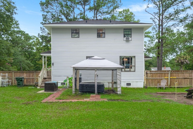 rear view of house with a lawn and a gazebo