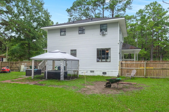 back of house with a gazebo and a yard