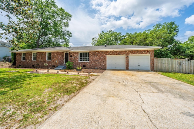 single story home with a garage, fence, a front yard, brick siding, and driveway