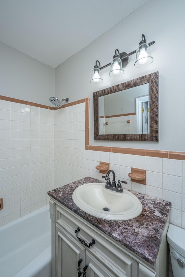 full bath featuring tile walls, toilet, and vanity