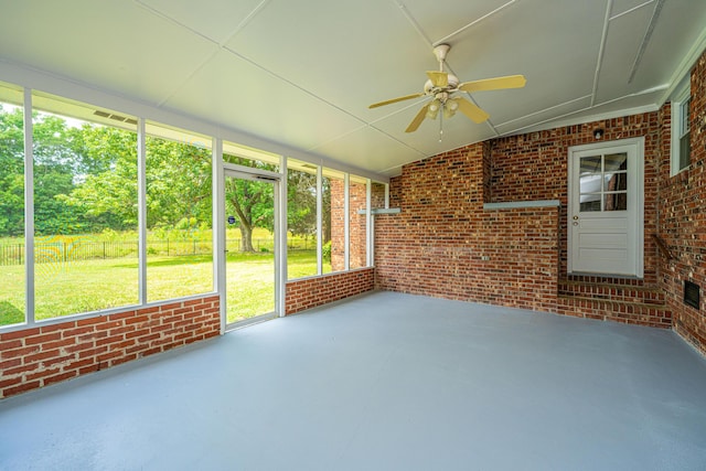 unfurnished sunroom featuring a ceiling fan