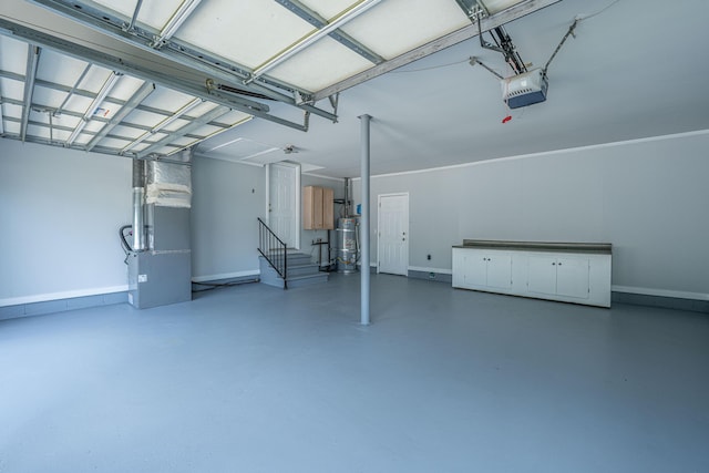 garage with baseboards, secured water heater, heating unit, and a garage door opener