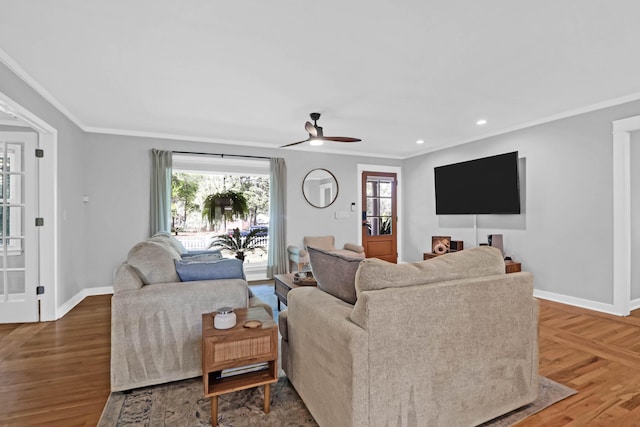 living room with crown molding, wood-type flooring, and ceiling fan