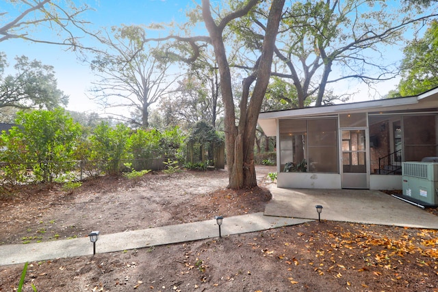 view of yard featuring a patio area and a sunroom