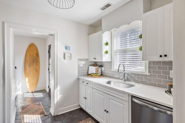 kitchen featuring a sink, white cabinetry, visible vents, decorative backsplash, and dishwasher