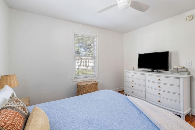 bedroom with dark wood-type flooring and ceiling fan