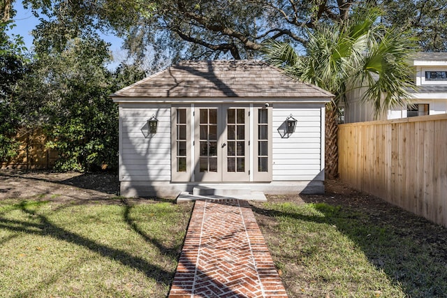 view of outdoor structure featuring an outbuilding and a fenced backyard