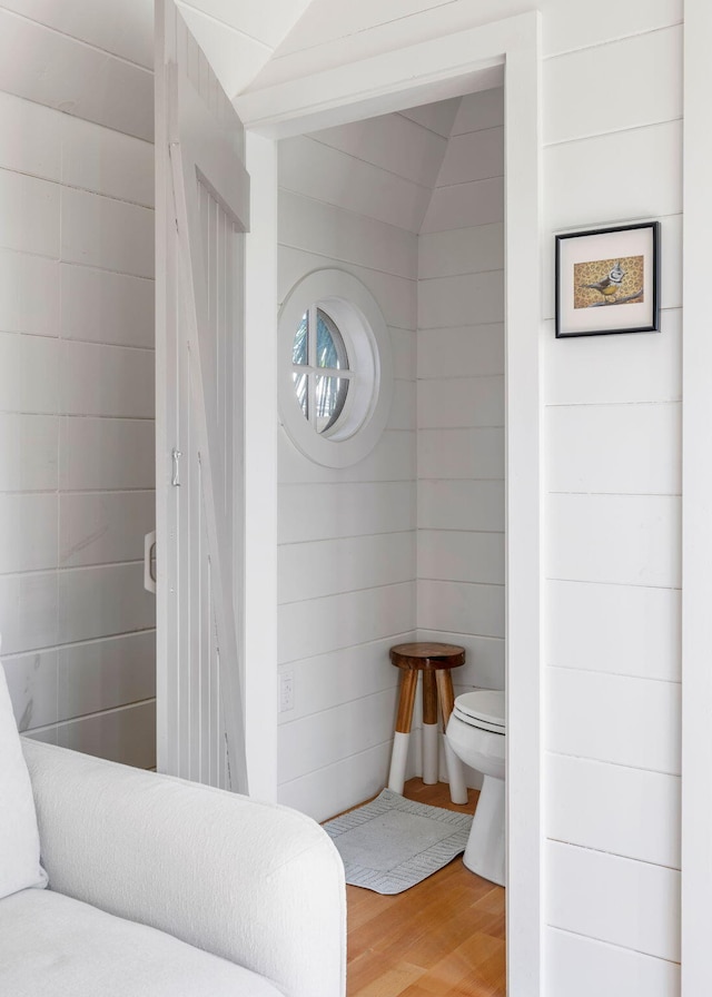 bathroom featuring toilet and wood finished floors