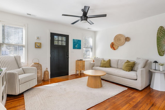 living area with wood-type flooring and visible vents