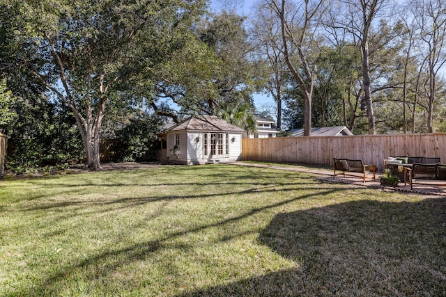 view of yard featuring an outbuilding and fence