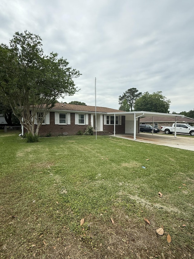 8612 Delhi Rd, North Charleston, SC 29406 - view of front facade with a front yard, a carport, and brick siding
