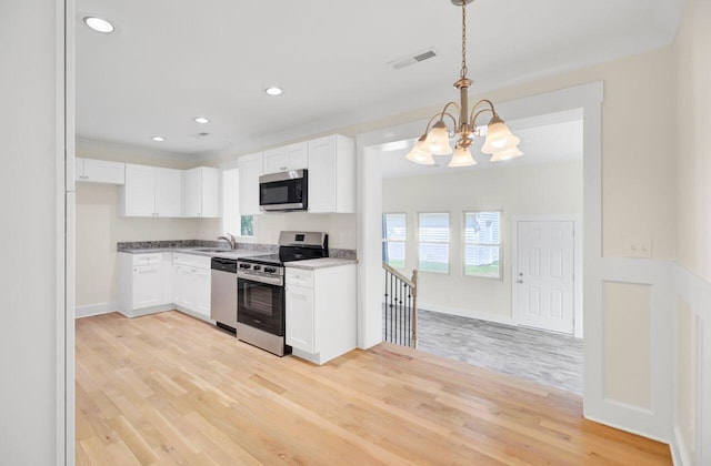 8612 Delhi Rd, North Charleston, SC 29406 - kitchen featuring appliances with stainless steel finishes, a chandelier, a sink, light wood finished floors, and recessed lighting