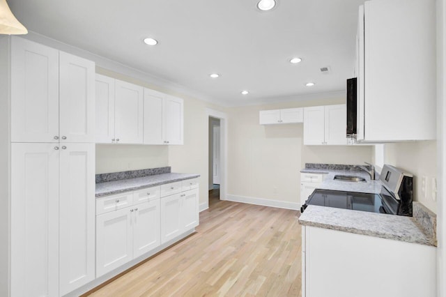 8612 Delhi Rd, North Charleston, SC 29406 - kitchen with white cabinetry, recessed lighting, baseboards, light wood-style floors, and ornamental molding